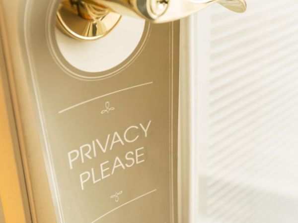 A door handle features a "Privacy Please" sign hanging, indicating a request for privacy.