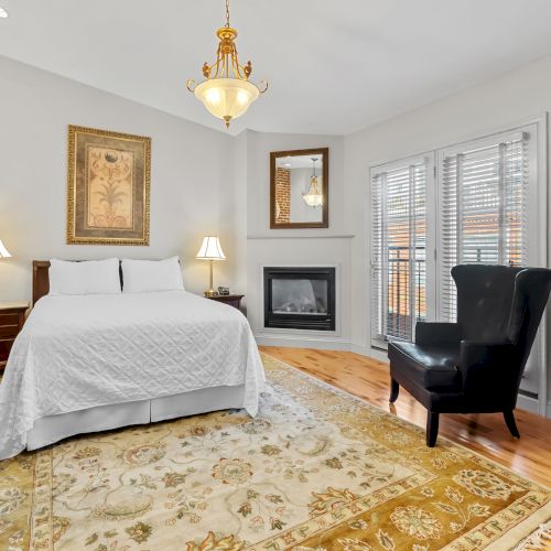 A cozy bedroom with a white bed, vintage nightstands, a wooden dresser, and decorative wall art, creating a warm, classic vibe.